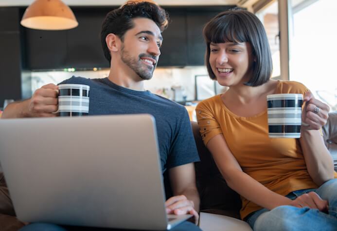 Fast, Reliable Internet in BC - young couple on sofa with laptop connected to NetJOI Internet