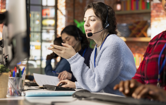 Why Customer Service is the new battleground in telecoms - 3 call center agents on phone dealing with upset customers