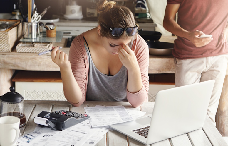 Why is Internet so expensive in Canada - couple sitting at table with Internet and other bills
