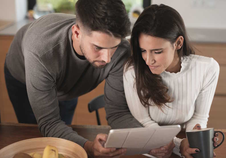 Male and female couple reviewing an Internet contract at home before choosing a provider in Canada